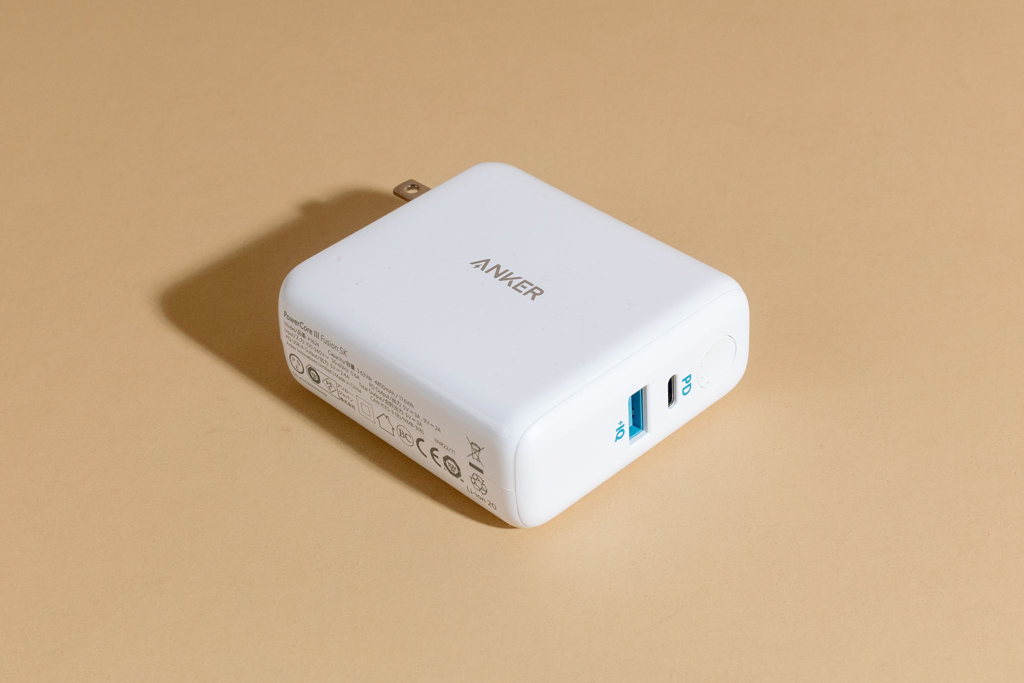 The white square Anker PowerCore III Fusion 5K, a top pick for best portable chargers and power banks for phones and tablets, has ports highlighted in bright blue.
